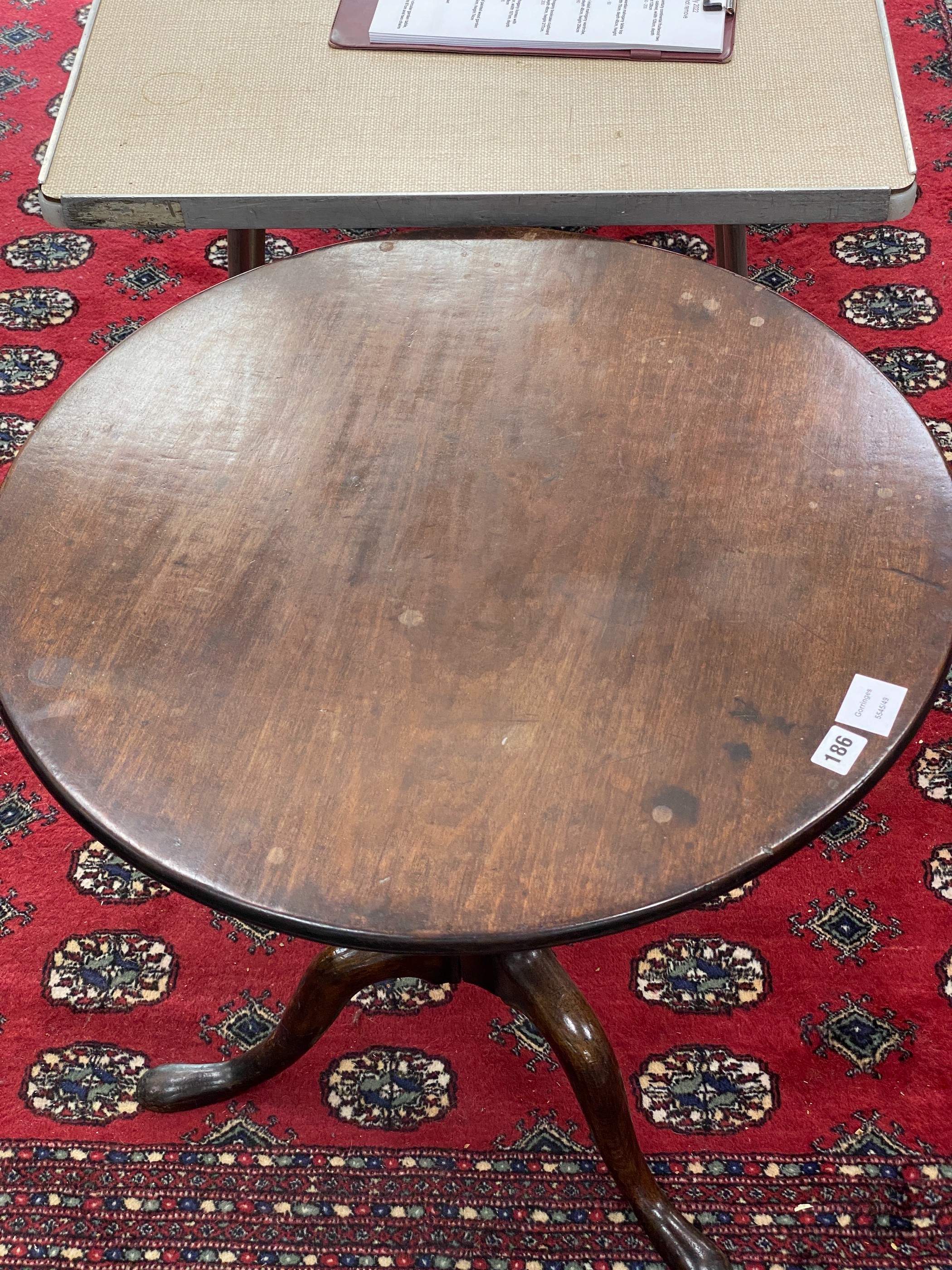 A George III mahogany circular tilt top tea table, with 'bird-cage' pillar and tripod supports, diameter 64cm, height 69cm